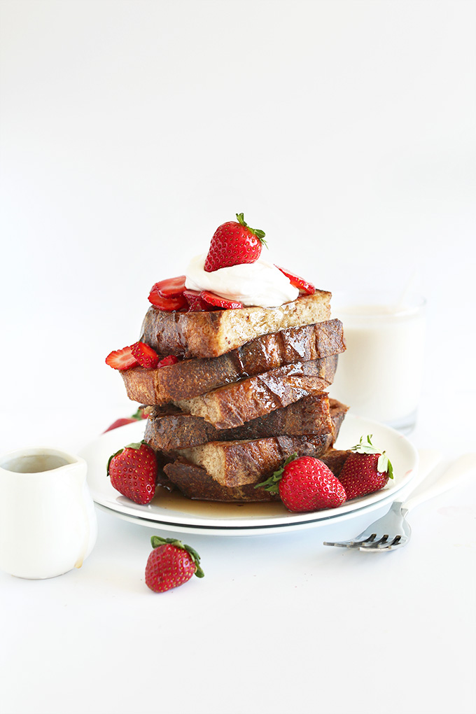 Tall stack of Vegan French Toast with Fresh Strawberries and Coconut Whipped Cream