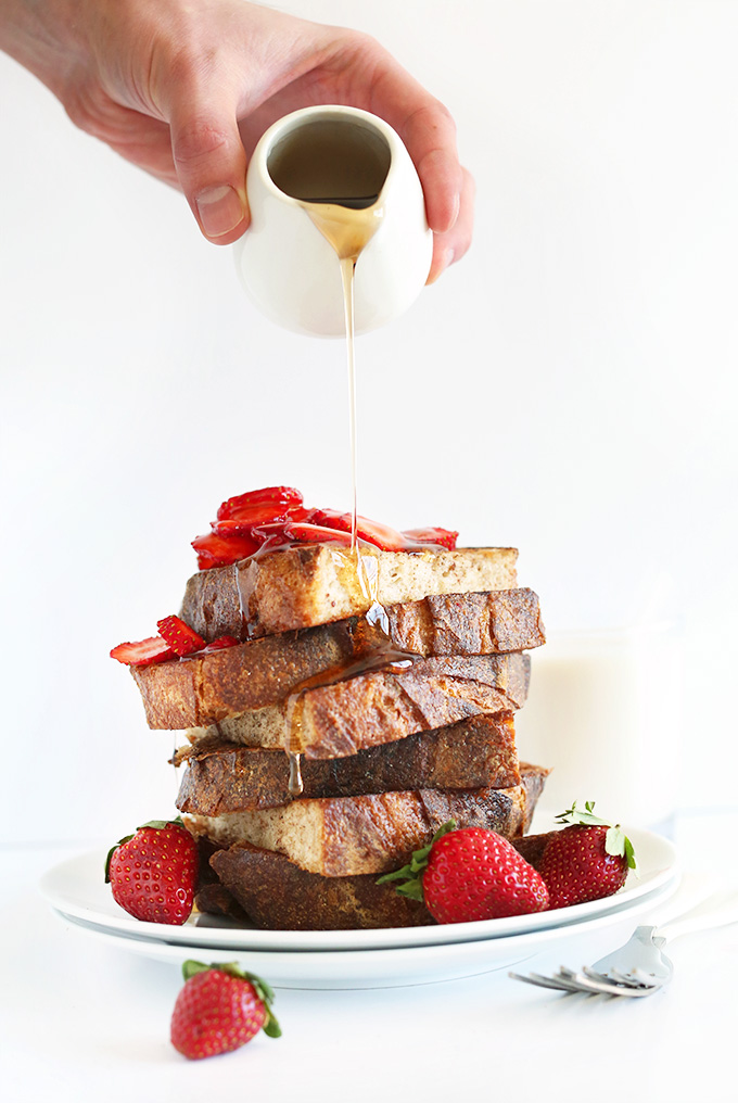 Pouring agave onto a stack of our Vegan French Toast recipe