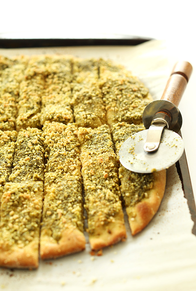Vegan Pesto Breadsticks sliced with a pizza cutter