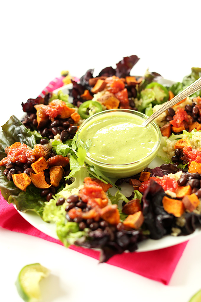 Plate of Mexican Quinoa Salad Cups with a bowl of cilantro-lime dressing