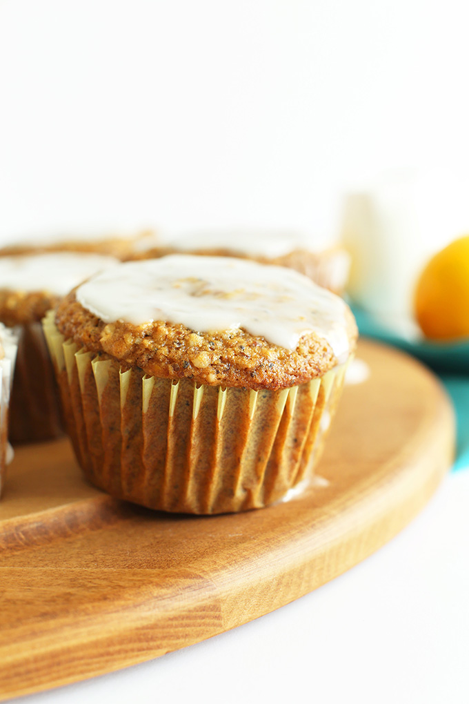 Cutting board of Meyer Lemon Poppy Seed Muffins topped with glaze