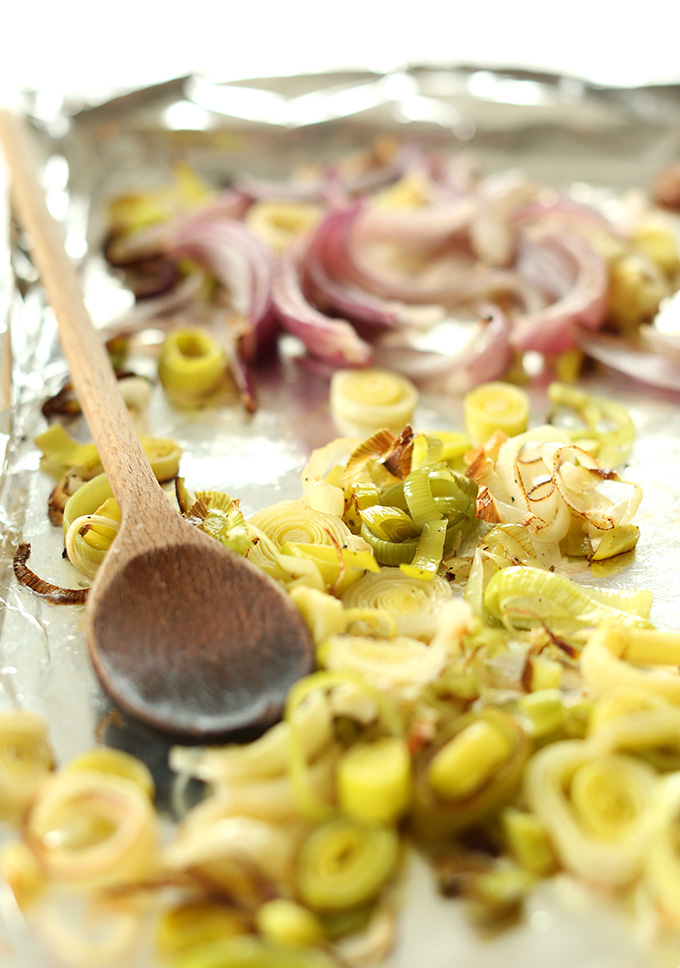 Aluminum-lined baking sheet with freshly roasted leeks and onions