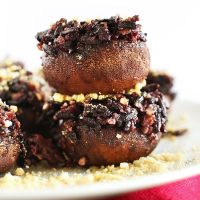 Plate filled with Vegan Stuffed Mushrooms topped with vegan parmesan