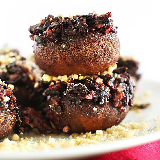 Plate filled with Vegan Stuffed Mushrooms topped with vegan parmesan