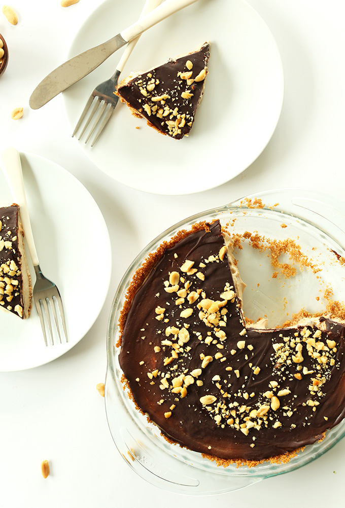 Plates with slices of Vegan Peanut Butter Cup Pie alongside the rest of the pie