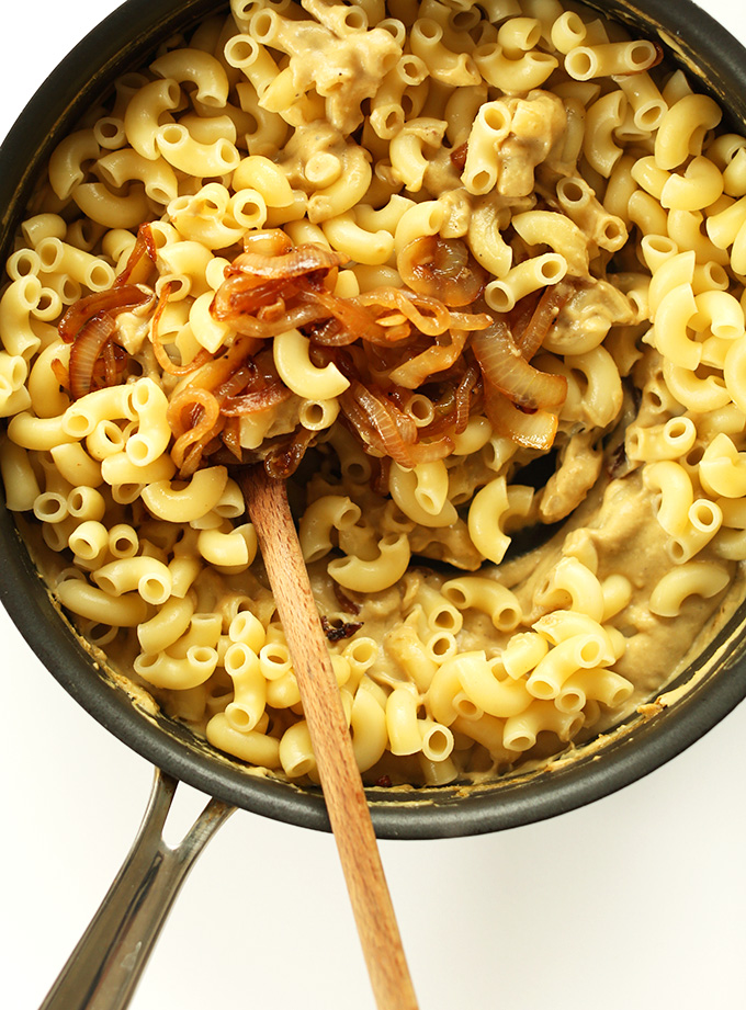 Caramelized onion and pasta in a pan for making vegan Caramelized Onion Mac n Cheese