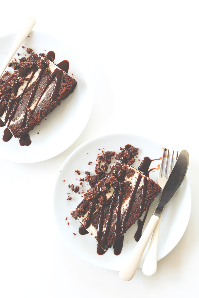 Plates with slices of Vegan Mint Chocolate Chip Ice Cream Cake and a chocolate drizzle