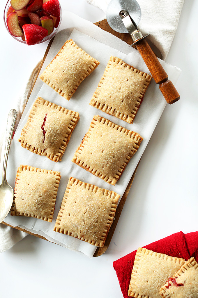 Freshly baked vegan Strawberry Rhubarb Pop Tarts on white parchment paper