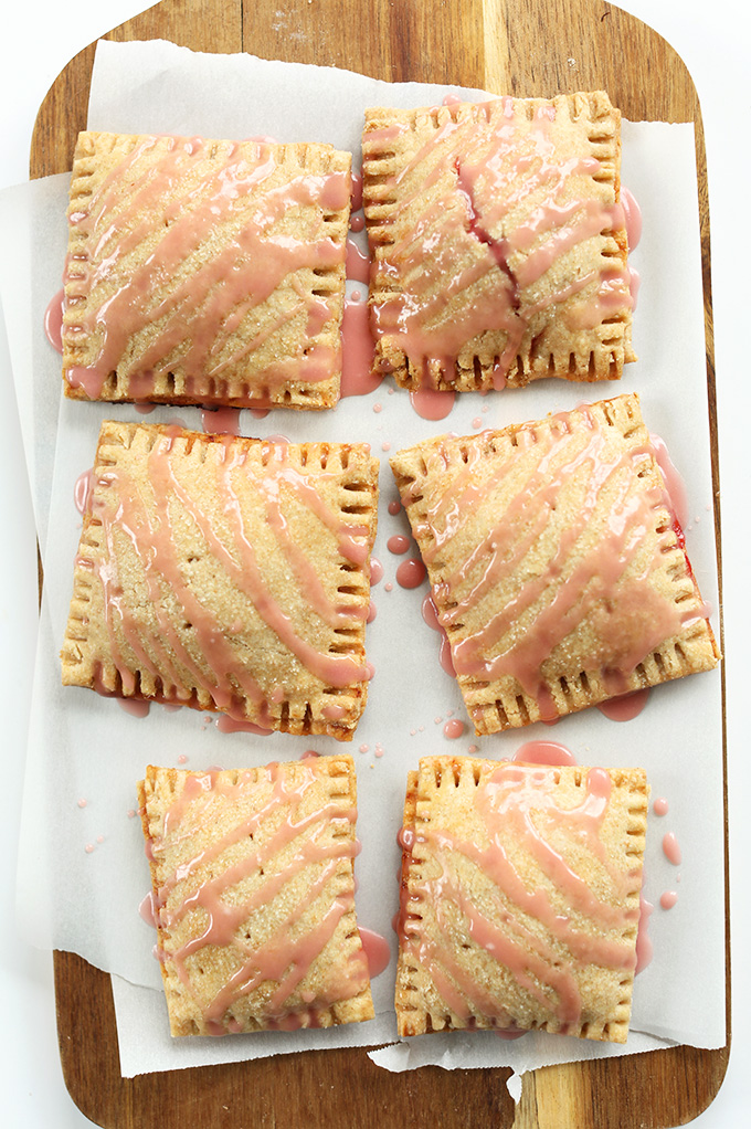 Homemade Vegan Strawberry Rhubarb Pop Tarts on a parchment-lined cutting board