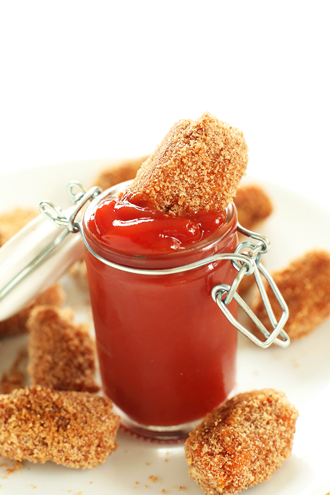 Dipping a homemade Sweet Potato Tater Tot into a jar of ketchup