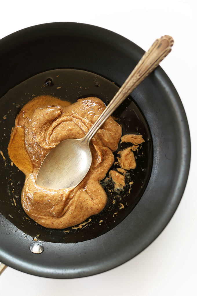 Mixing together agave and almond butter for gluten-free vegan granola bars