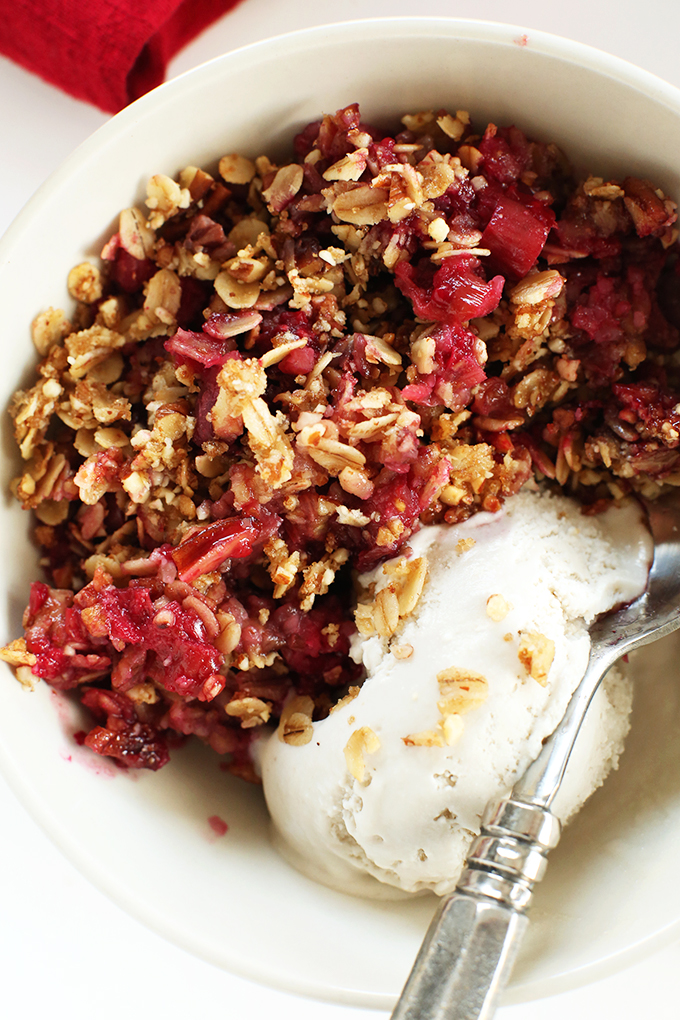 Bowl of Raspberry Rhubarb Crisp with vegan vanilla ice cream