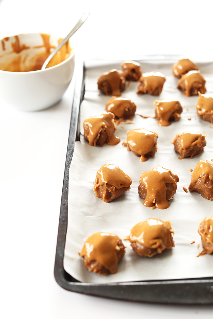 Baking sheet of Vegan PB Caramel Truffles ready to be topped with chocolate