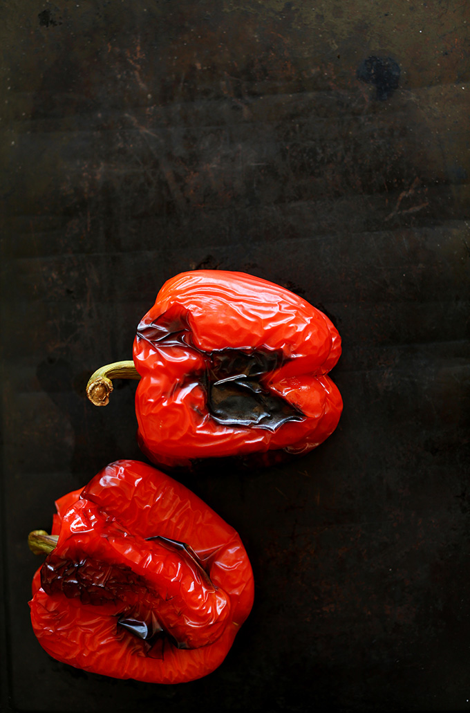 Baking sheet with freshly roasted red peppers for making sauce