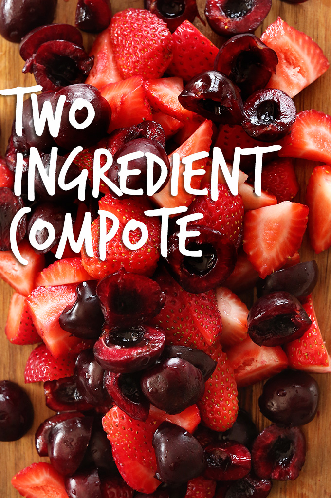 Cutting board with fresh cherries and raspberries for making our homemade fruit compote recipe