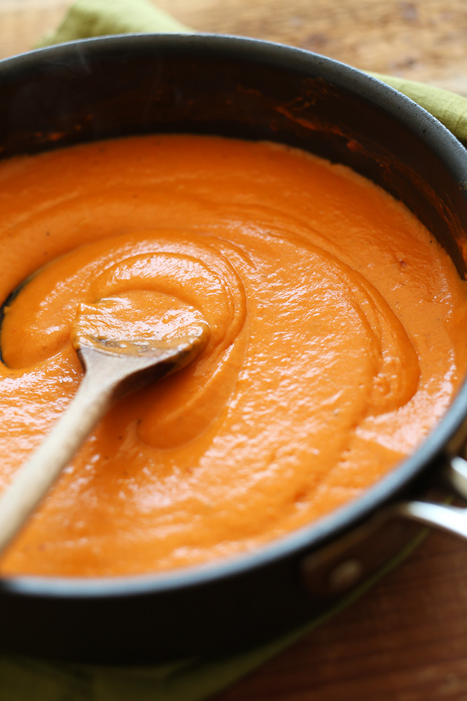 Using a wooden spoon to stir together our Vegan Roasted Red Pepper Pasta sauce
