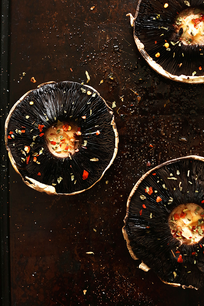 Baking sheet with Portobello mushrooms topped with spices