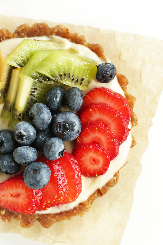 Parchment-square topped with a gluten-free vegan Lemon Cookie Fruit Tart