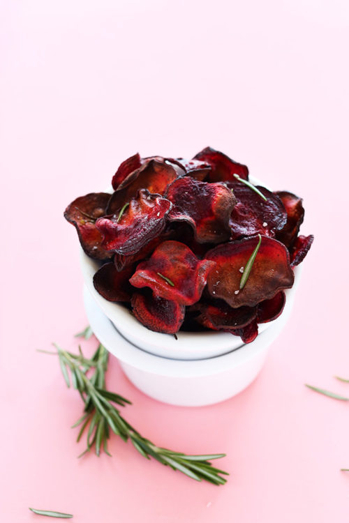 Stack of bowls with the top one overfilled with Baked Rosemary Beet Chips