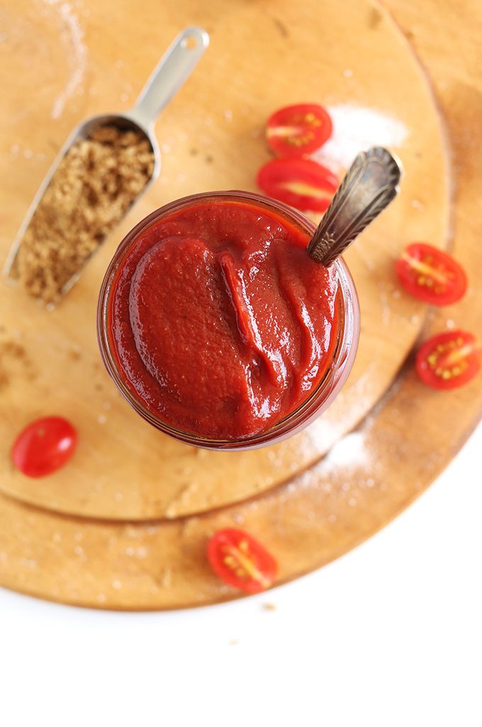 Top down shot of a jar of Whiskey BBQ Ketchup and ingredients used to make it