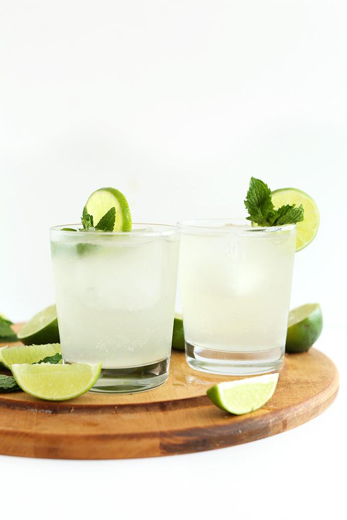 Glasses of Coconut Water Gin and Tonics on a wood cutting board