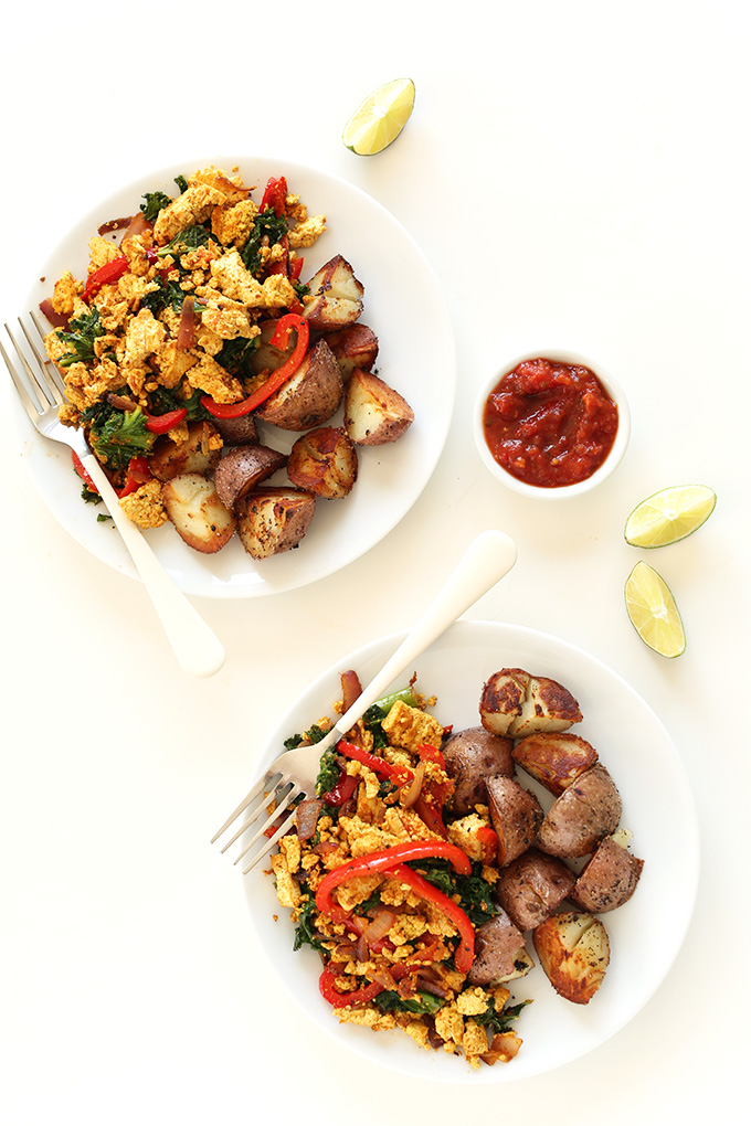 Two plates of vegan scramble and roasted potatoes