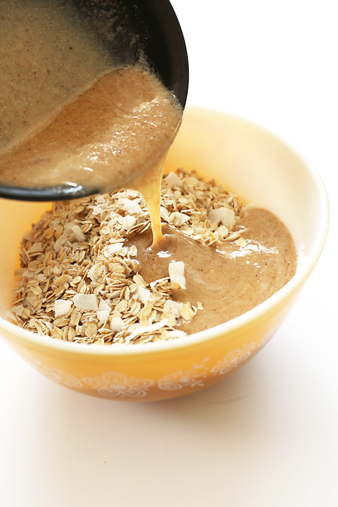 Pouring wet ingredients into dry for our Simple Almond Joy Granola recipe