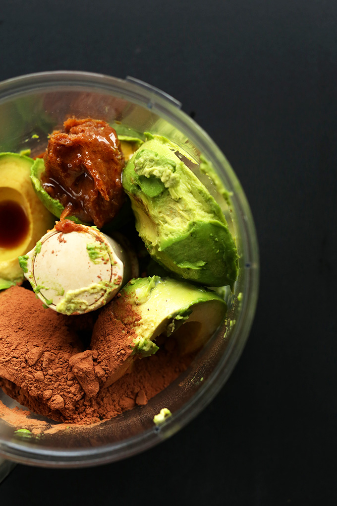 Food processor with ingredients for making vegan Chocolate Avocado Pudding