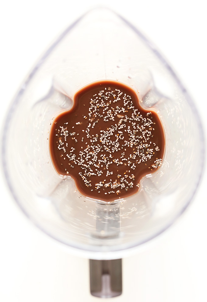 Blender of Chocolate Coconut Recovery Drink topped with chia seeds