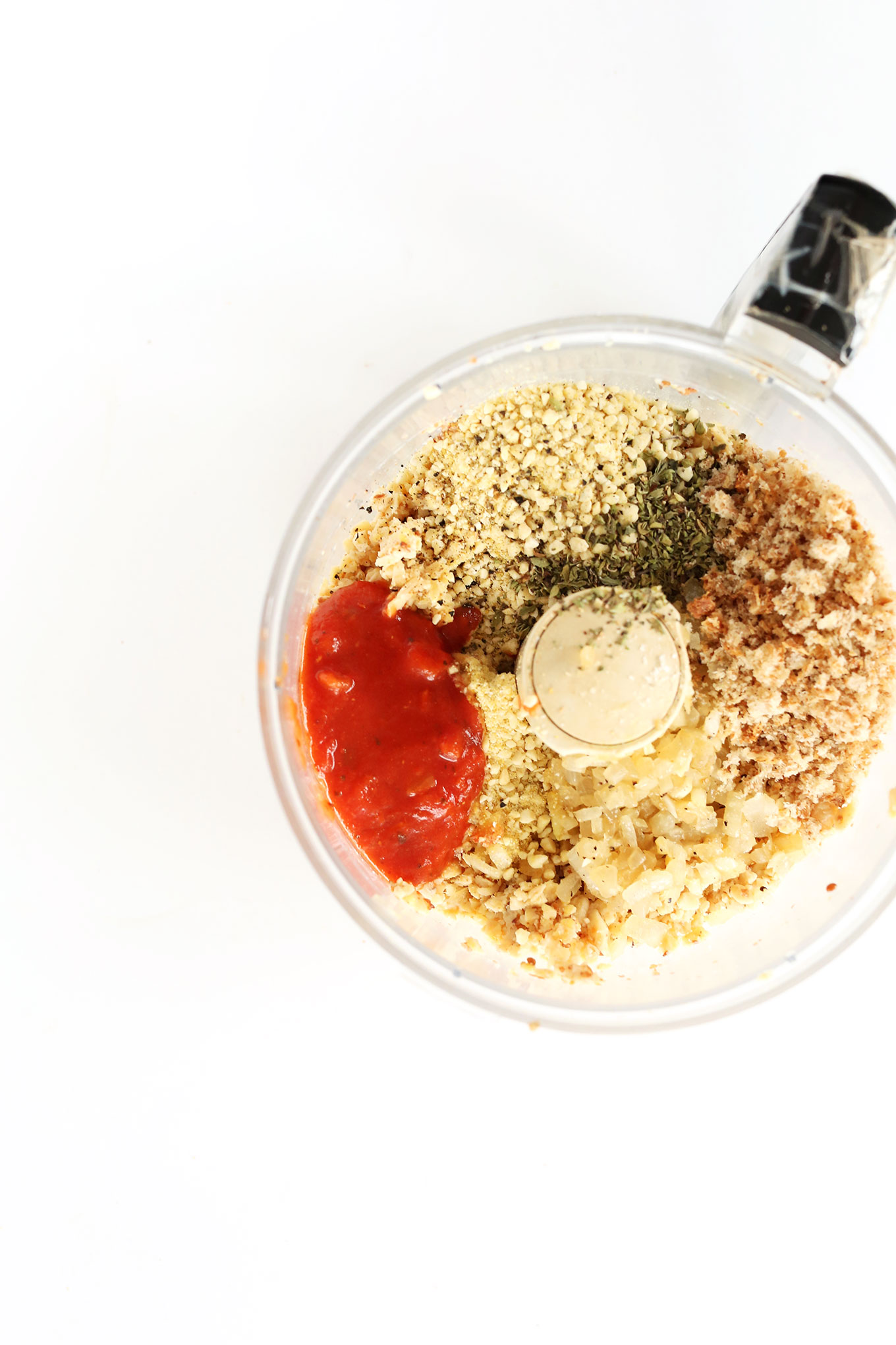 Food processor with ingredients for making our homemade vegan meatballs recipe