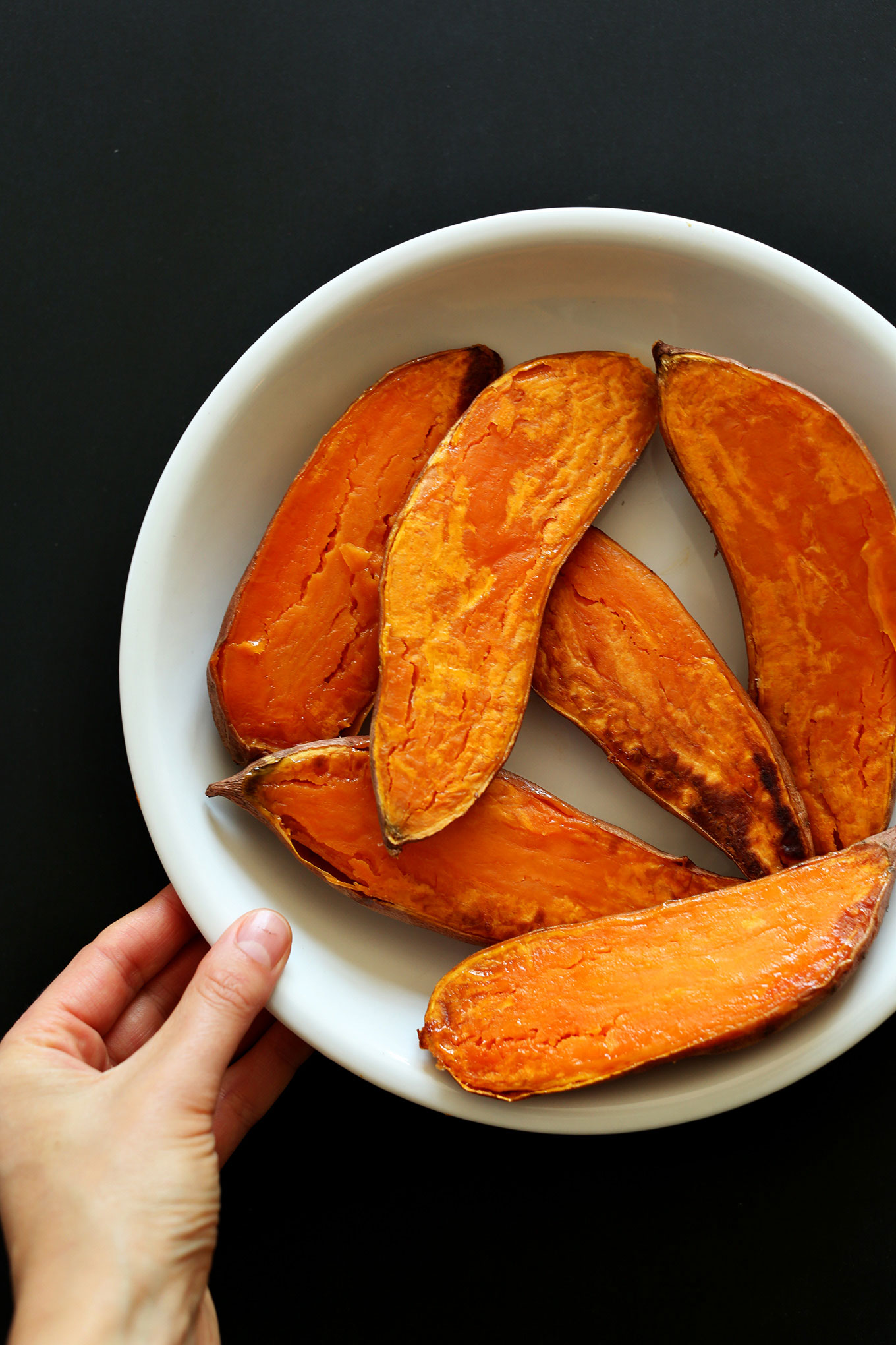 Big bowl of freshly roasted halved sweet potatoes