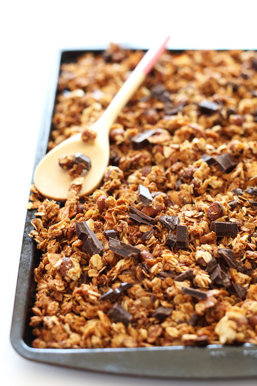 Baking sheet of Almond Joy Granola made with oats, almonds, coconut, and dark chocolate