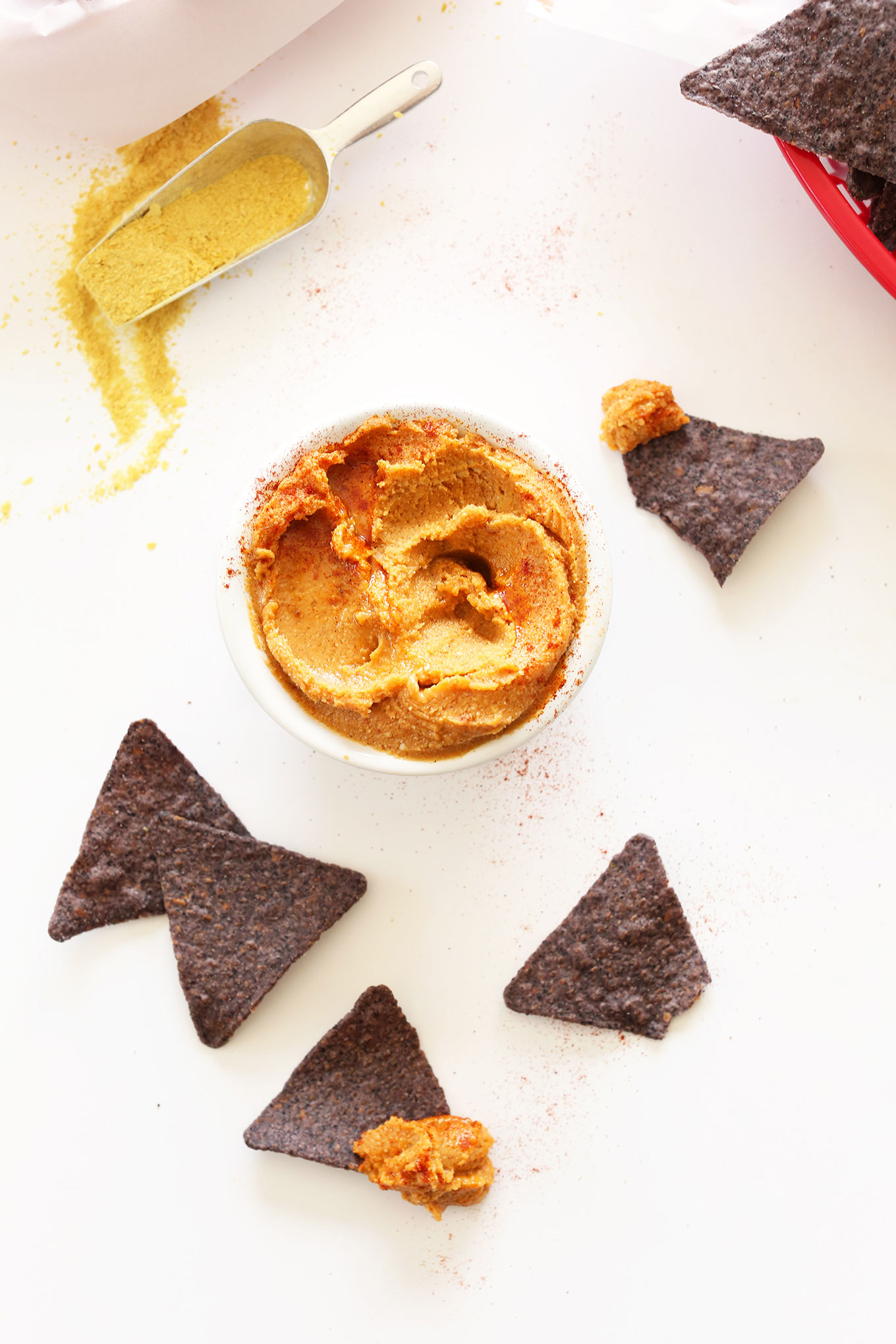 Blue corn tortilla chips and a bowl of simple Vegan Mexican Cheese Spread