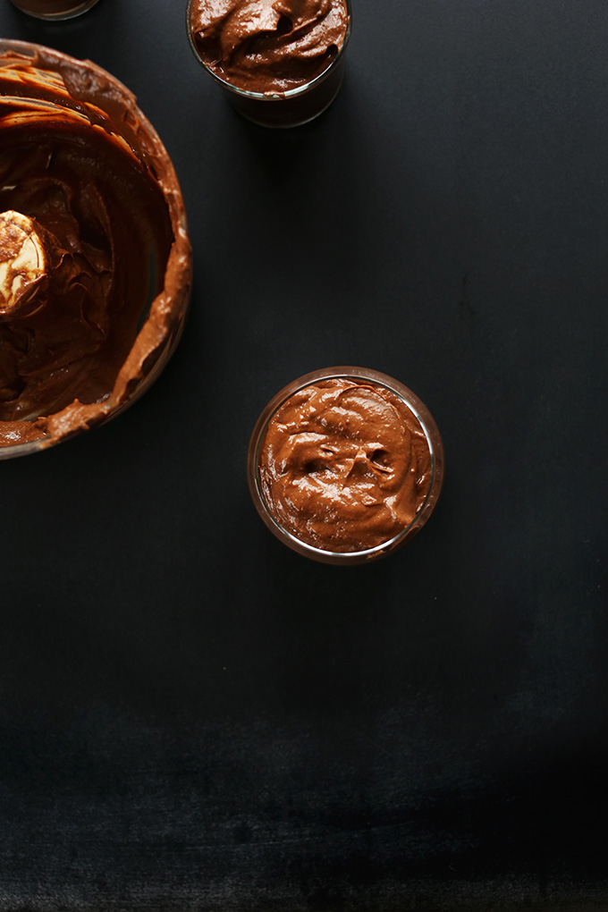 Food processor and glass jars of vegan Chocolate PB Avocado Pudding