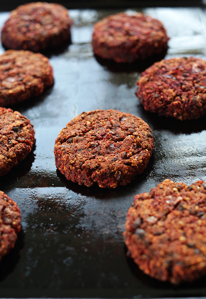 Flavorful vegan Black Bean Beet Burgers on a baking sheet