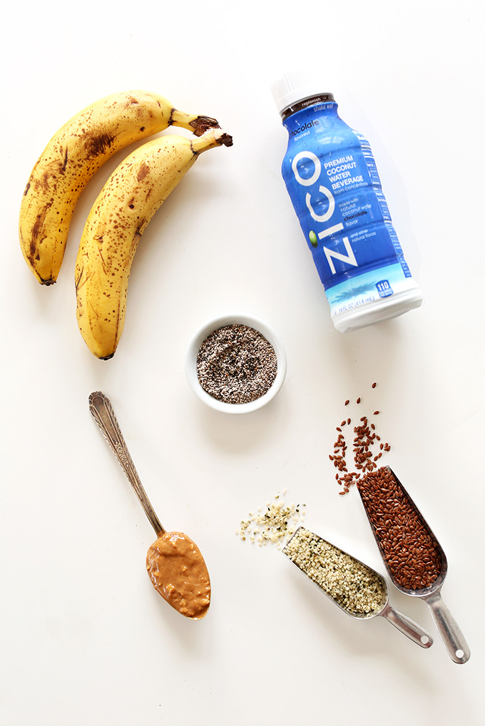 Coconut water and other ingredients for making a homemade chocolate coconut water drink