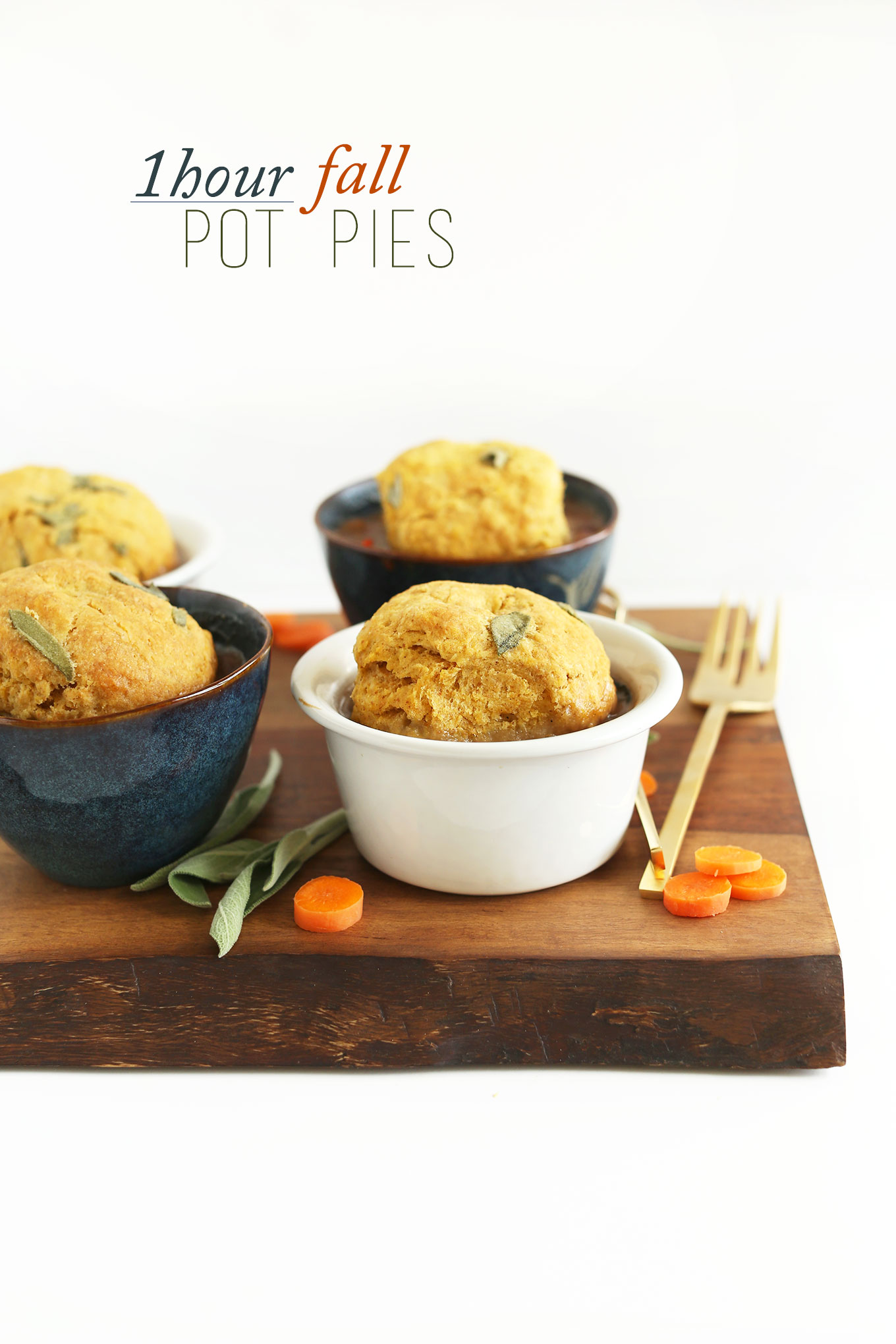 Cutting board with bowls of Veggie Fall Pot Pies with Pumpkin Sage Biscuits