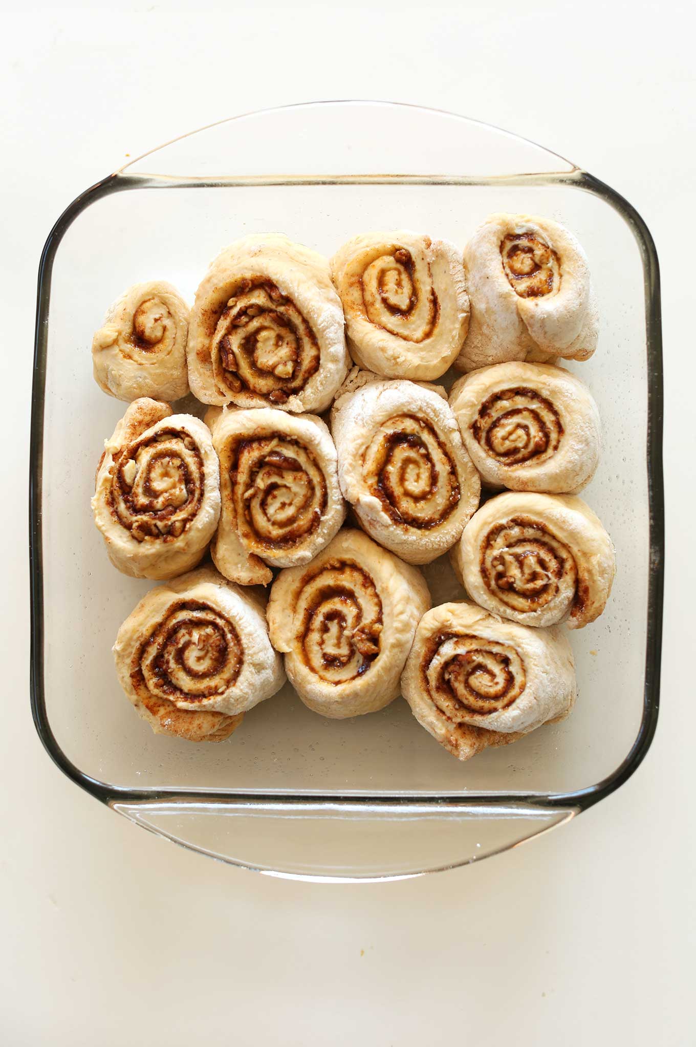 Baking pan filled with ready-to-bake Vegan Pumpkin Cinnamon Rolls