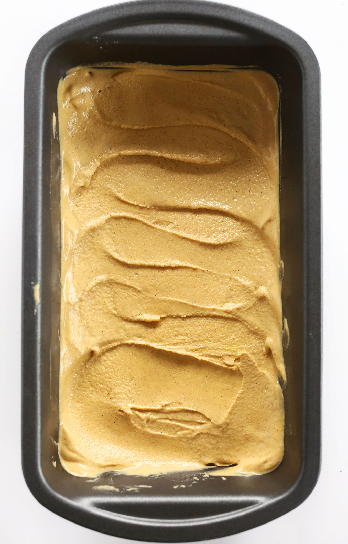 Loaf pan filled with a batch of our homemade Vegan Pumpkin Ice Cream recipe