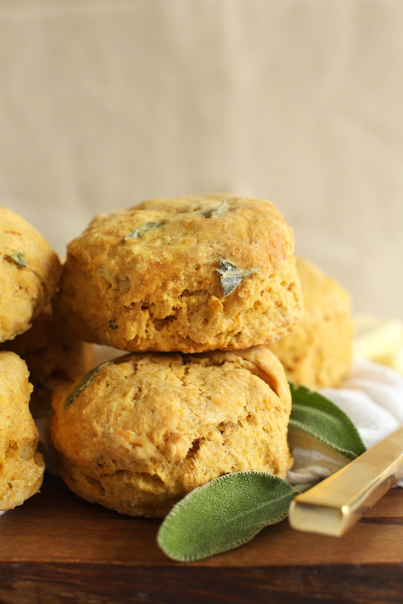 Pile of fluffy Pumpkin Sage Biscuits on a cutting board