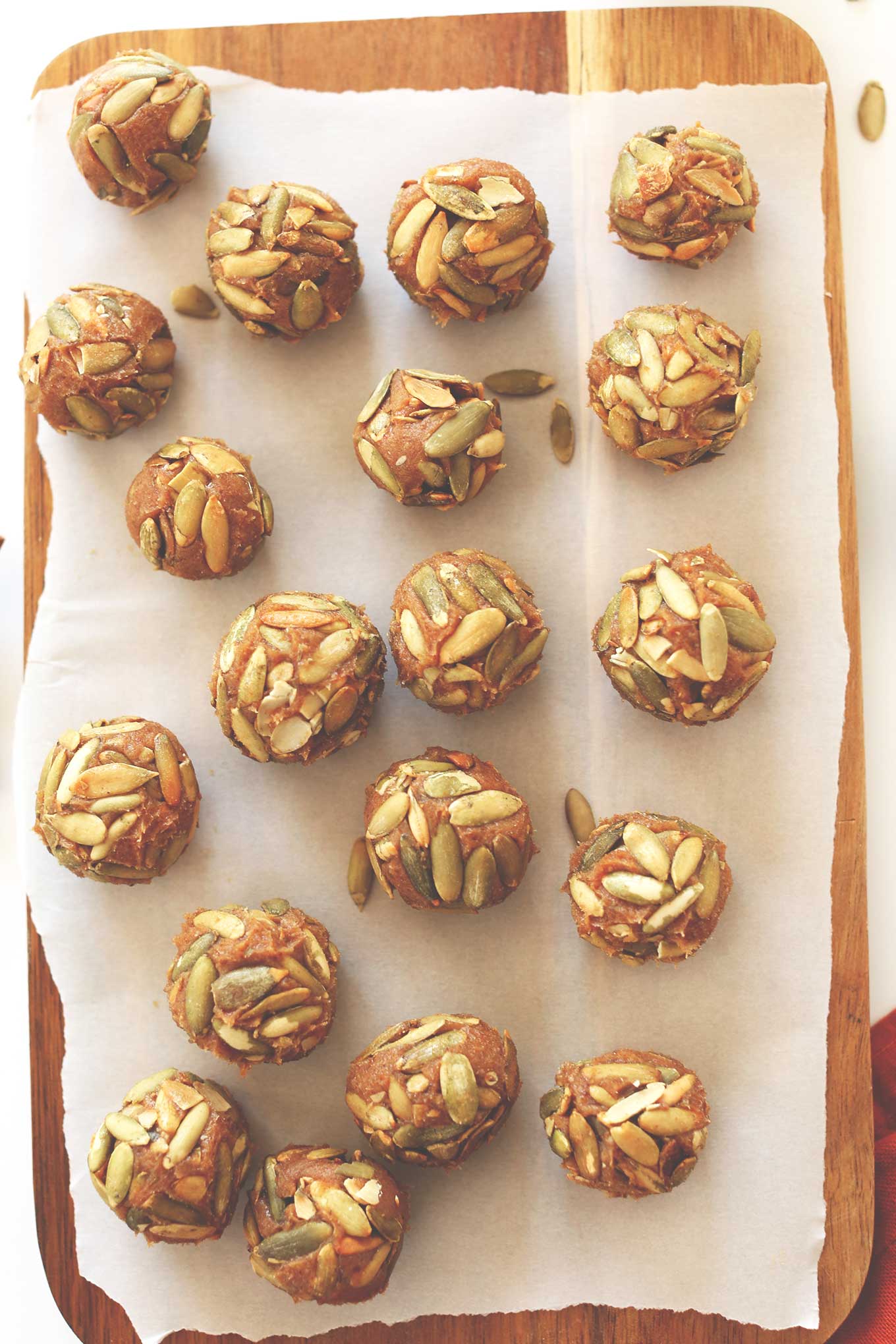 Parchment lined cutting board filled with vegan Pumpkin Caramels