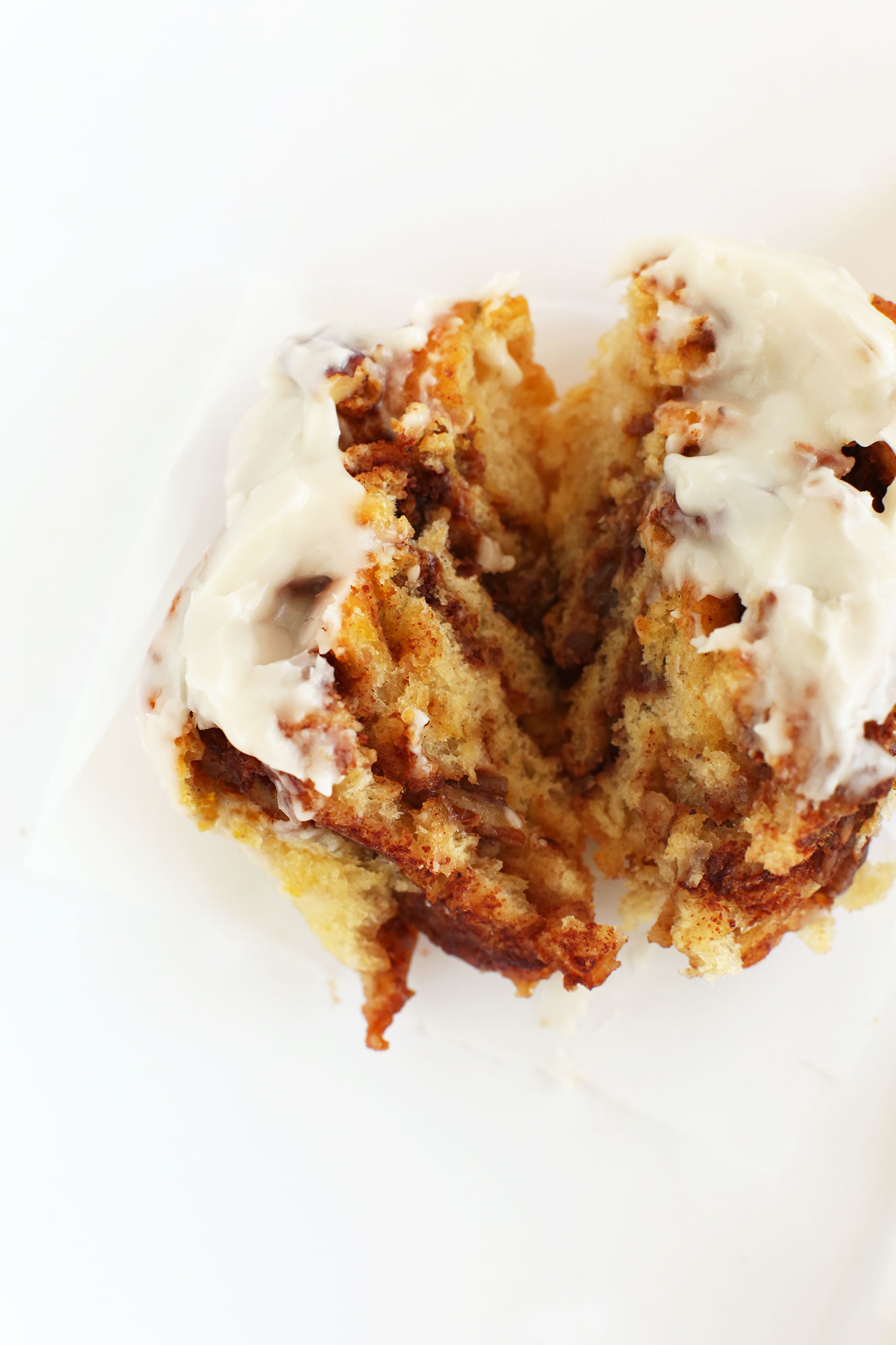 Cut open gooey Pumpkin Cinnamon Roll with icing