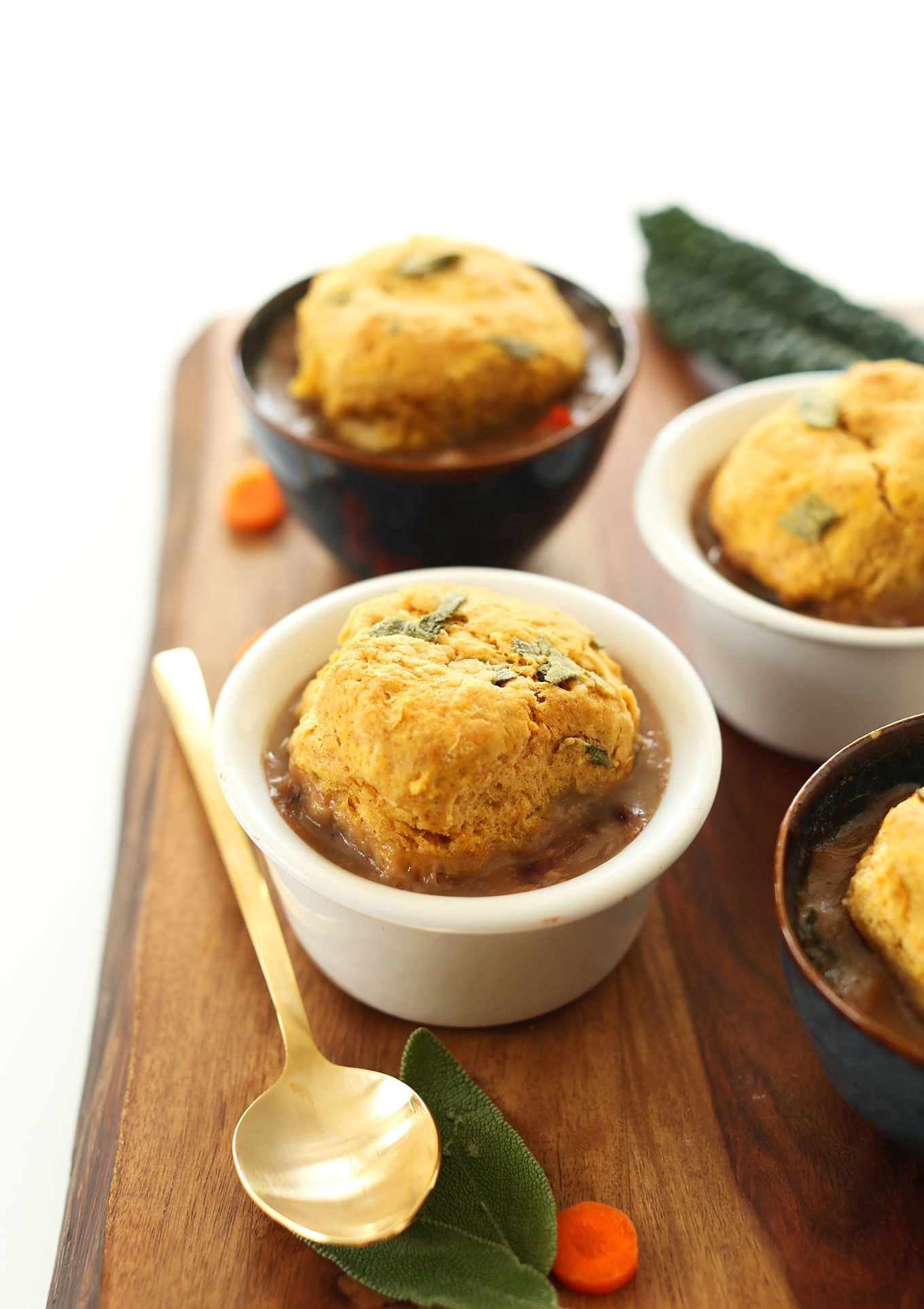 Cutting board filled with bowls of our Fall Pot Pies recipe