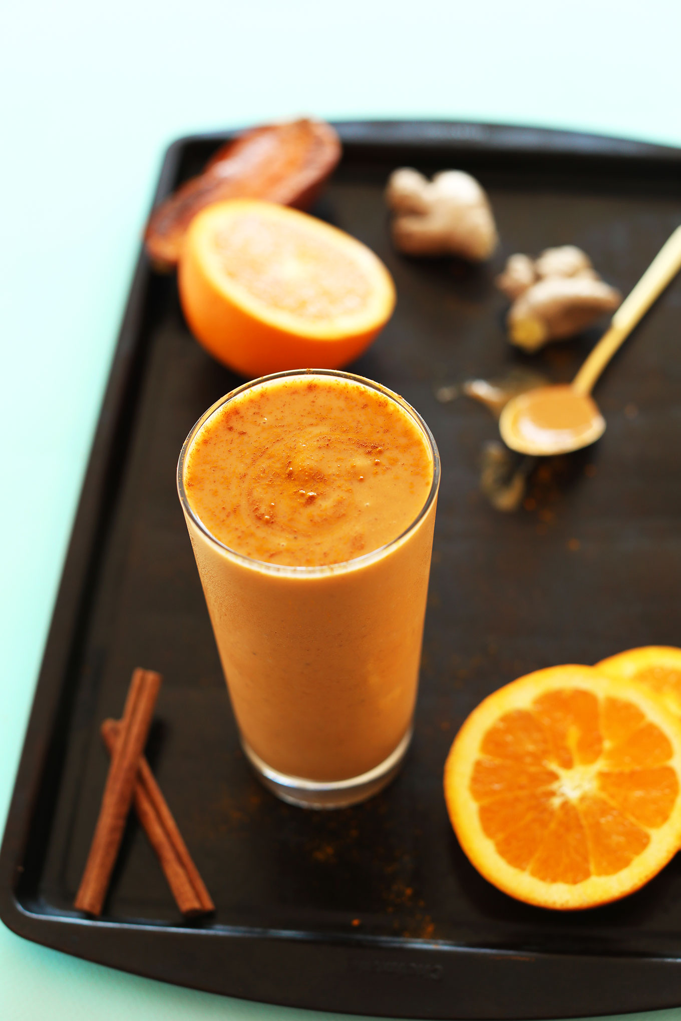 Glass of our Creamy vegan Sweet Potato Smoothie with oranges, cinnamon, and ginger