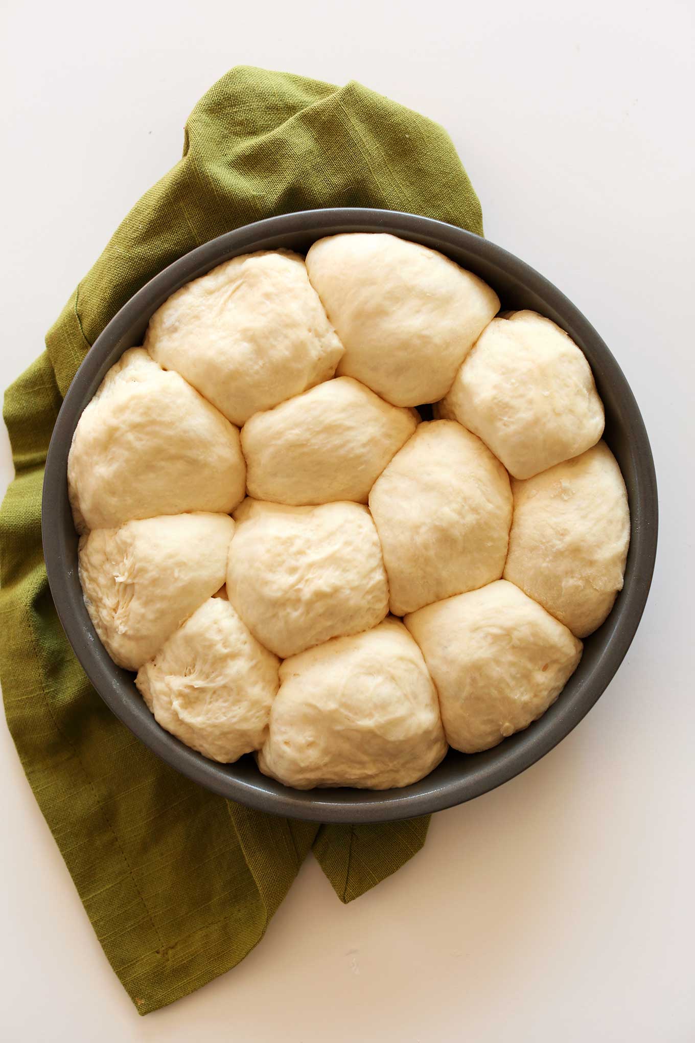 Pan of fluffy Vegan Dinner Rolls finishing proofing
