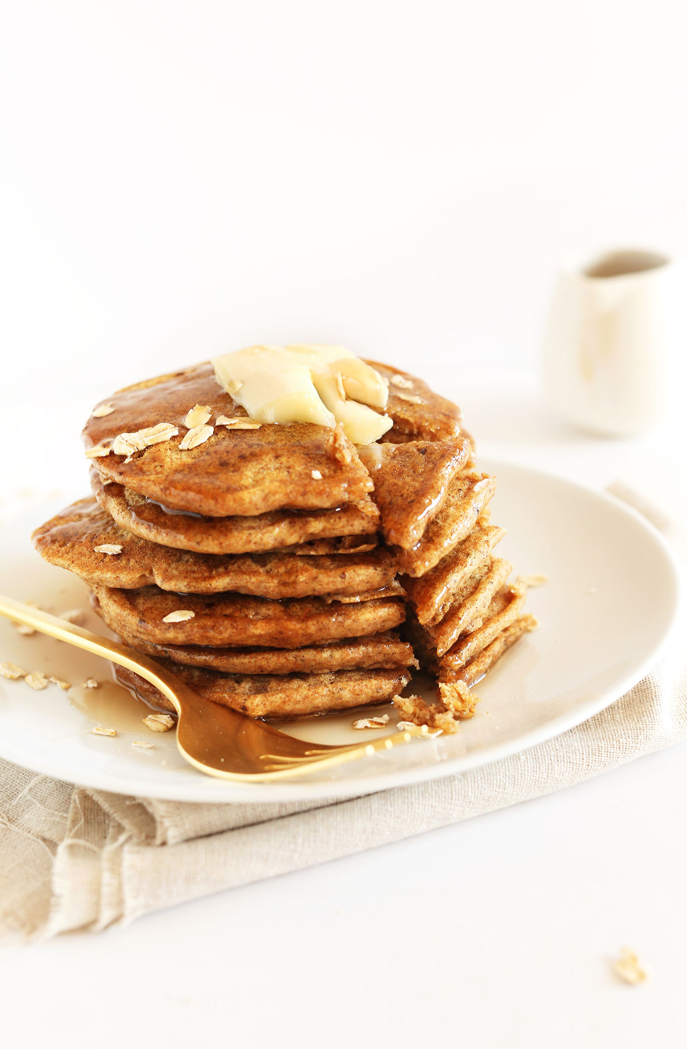 Cutting into a stack of Whole Grain Vegan Pancakes made with spelt flour