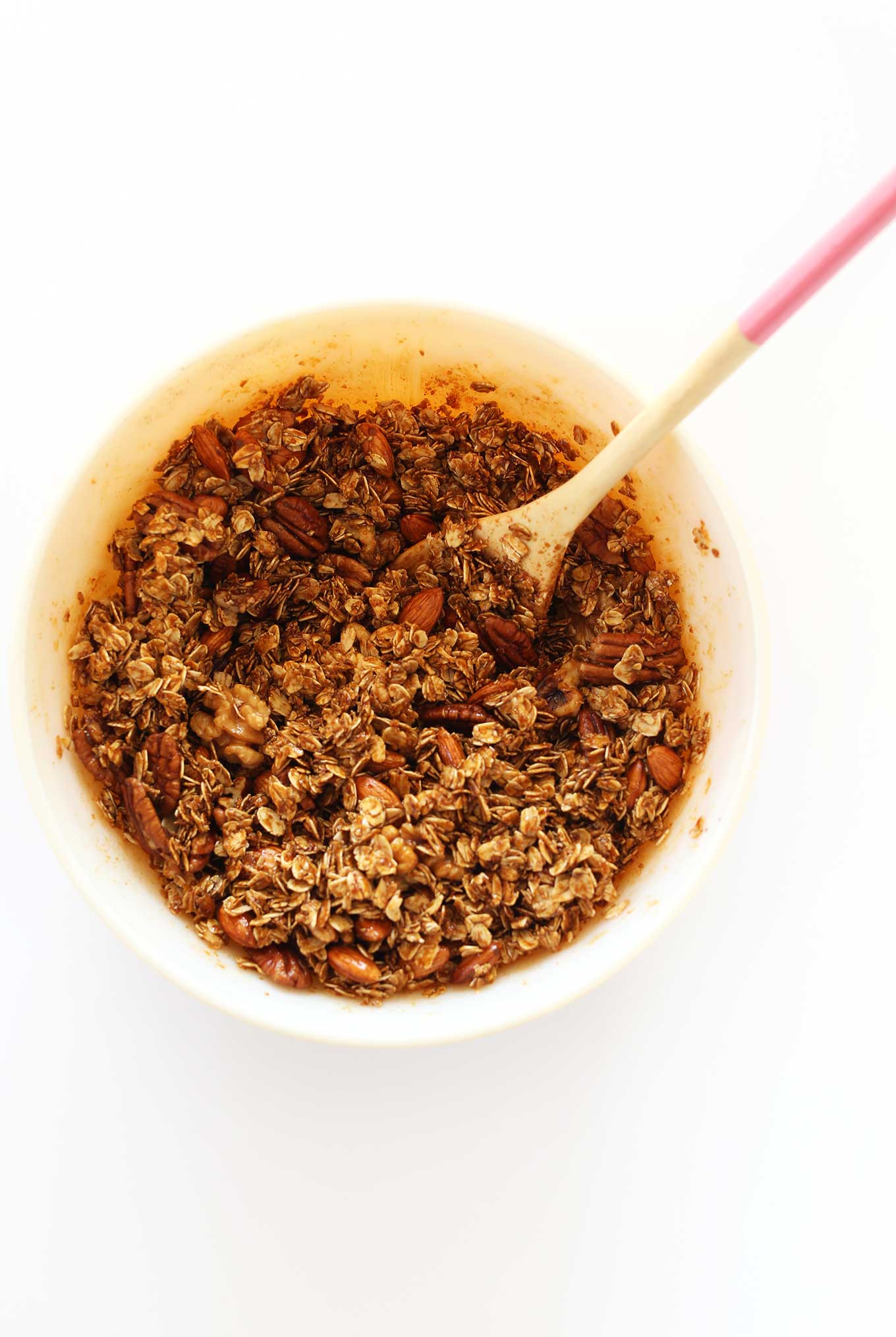 Oats, nuts, seeds, and spices stirred together for our healthy Gingerbread Granola recipe