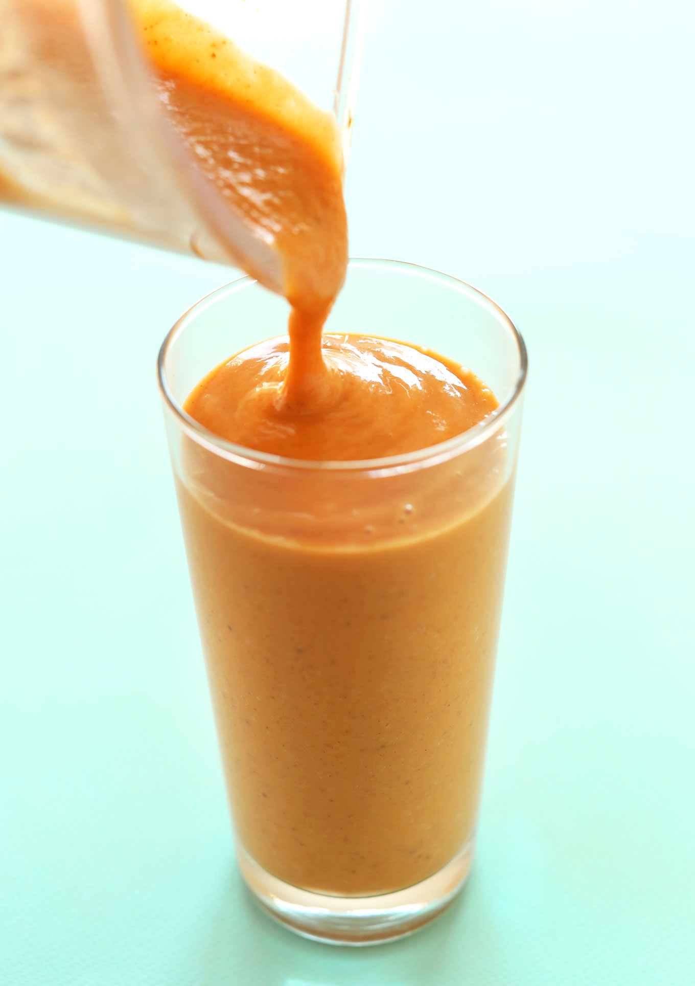 Pouring a glass of our nutrient-packed vegan Sweet Potato Smoothie