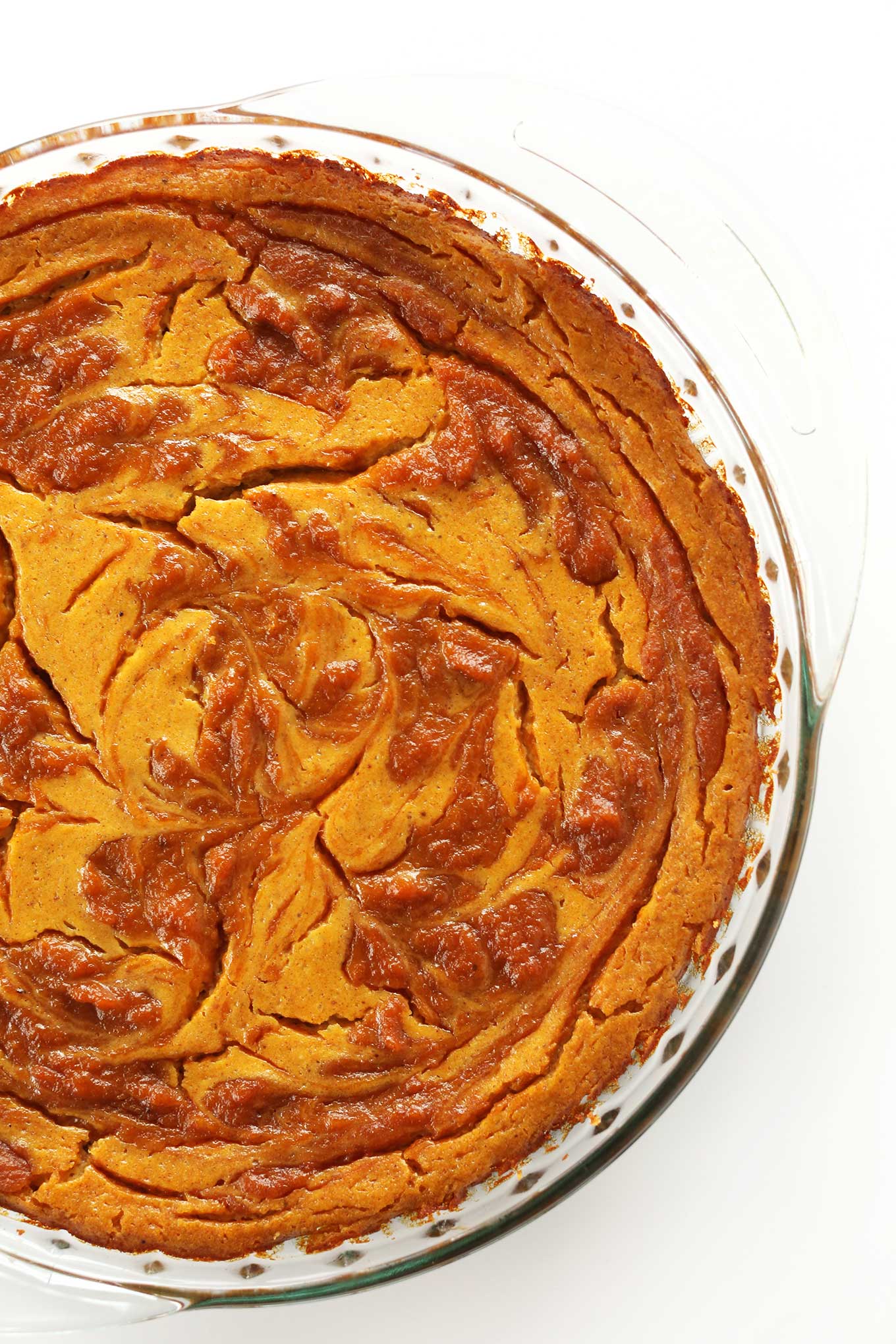 Freshly baked Vegan Pumpkin Swirl Cheesecake in a pie pan
