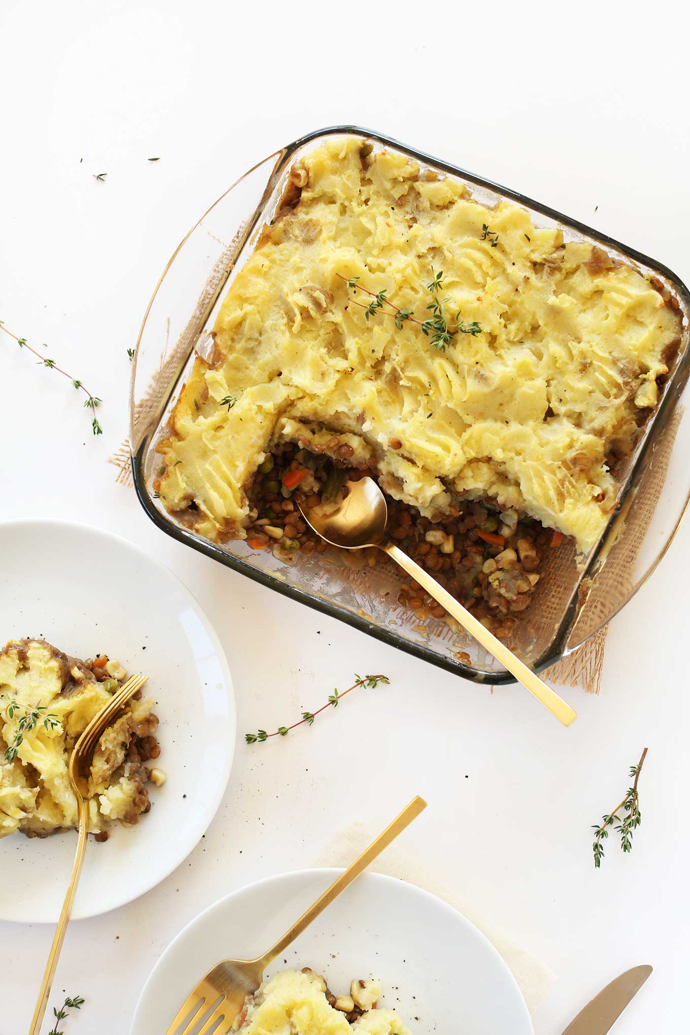 Glass baking dish and plate filled with simple gluten-free vegan Shepherds Pie